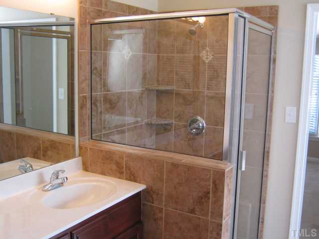 5816 Edgebury Road Raleigh, NC 27613 - Photo 4 of 12 Master bath features new tiled shower with new enclosure, custom tile work, separate garden tub, tile floors, separate water closet, new double sink vanity with cultured marble countertop!