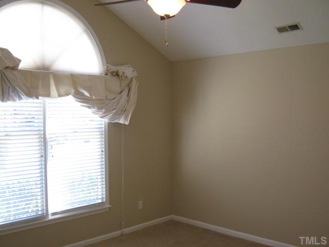 5816 Edgebury Road Raleigh, NC 27613 - Photo 5 of 12 First floor master bedroom with vaulted ceiling, new ceiling fan, phone and cable ready, walk-in closet, lovely palladium window provides wonderful natural light source! New carpet 2010!