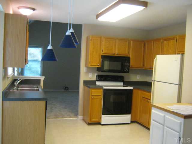 5816 Edgebury Road Raleigh, NC 27613 - Photo 6 of 12 Kitchen features New Paint, updated countertops, built-in microwave, deep sink, smooth top range, pantry, and has an eat-in breakfast area with bay window!