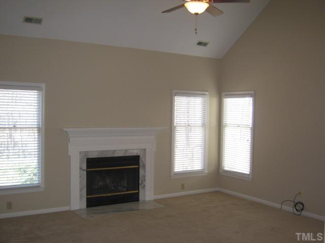 5816 Edgebury Road Raleigh, NC 27613 - Photo 9 of 12 Your living room features vaulted ceiling, fireplace with marble surround, new ceiling fan, new carpet in 2010!