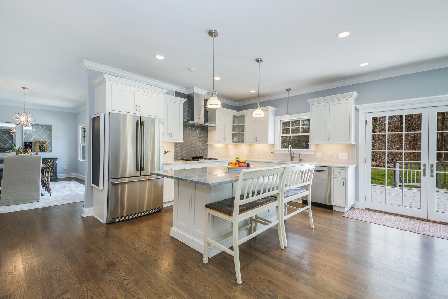 729 Cheese Spring Road New Canaan, CT 06840 - Photo 2 of 37 a kitchen with stainless steel appliances a refrigerator a stove a sink dishwasher and a dining table with wooden floor