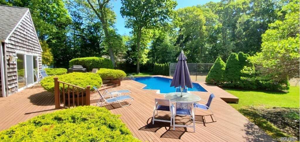 20 Basket Neck Lane Remsenburg, NY 11960 - Photo 1 of 1 a view of a patio with table and chairs potted plants and large tree