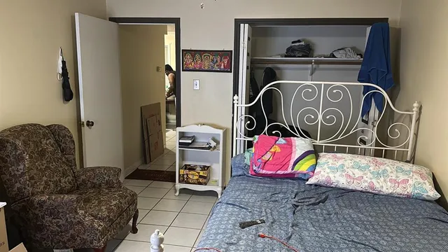 a bedroom with bed and cabinets