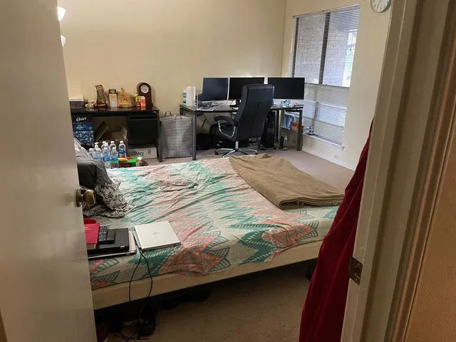 a bed room with a bed and a television