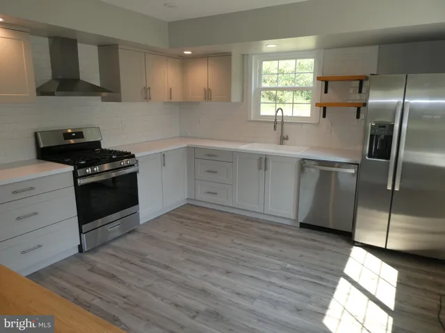 a kitchen with a sink stove and refrigerator