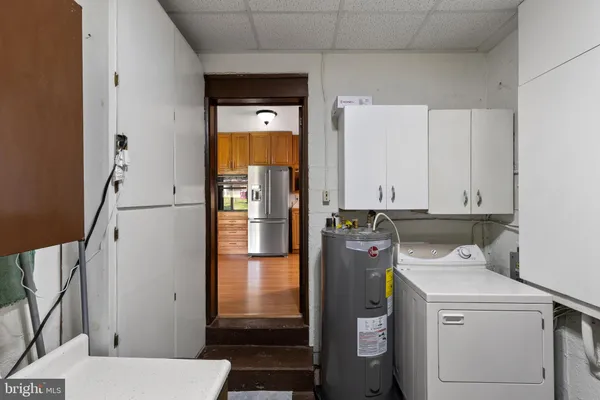 a view of a backyard with table and chairs and a large tree
