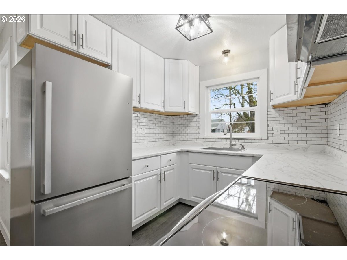 1084 24th Street Northeast Salem, OR 97301 - Photo 14 of 30 a kitchen with a refrigerator and a sink