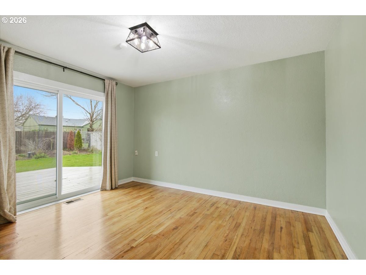 1084 24th Street Northeast Salem, OR 97301 - Photo 18 of 30 a view of an empty room with wooden floor and a window