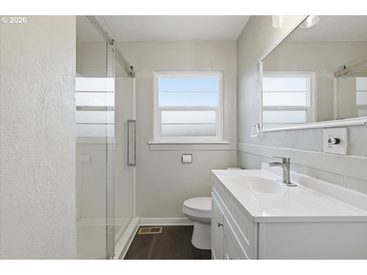 1084 24th Street Northeast Salem, OR 97301 - Photo 24 of 30 a bathroom with a sink a toilet and a window