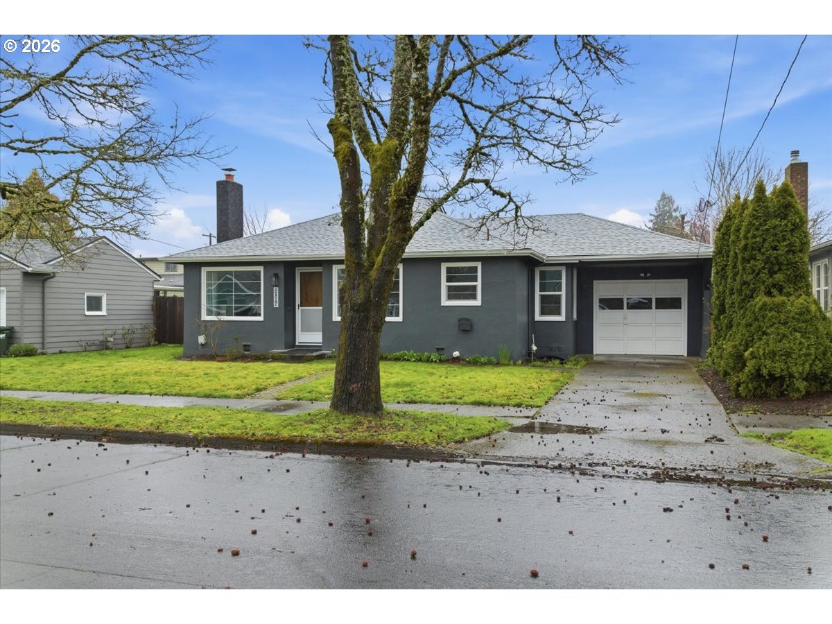 1084 24th Street Northeast Salem, OR 97301 - Photo 3 of 30 a front view of a house with a yard and garage