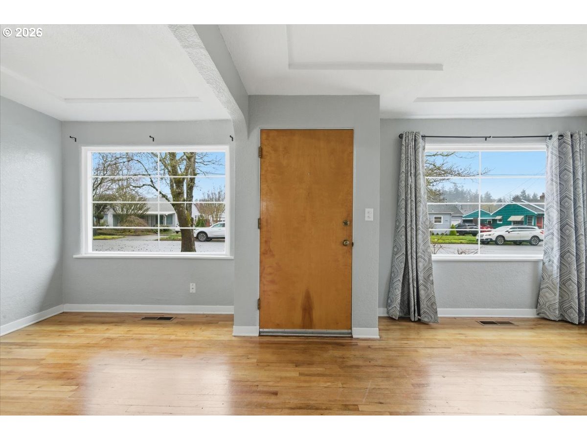 1084 24th Street Northeast Salem, OR 97301 - Photo 5 of 30 a view of an empty room with wooden floor and a window