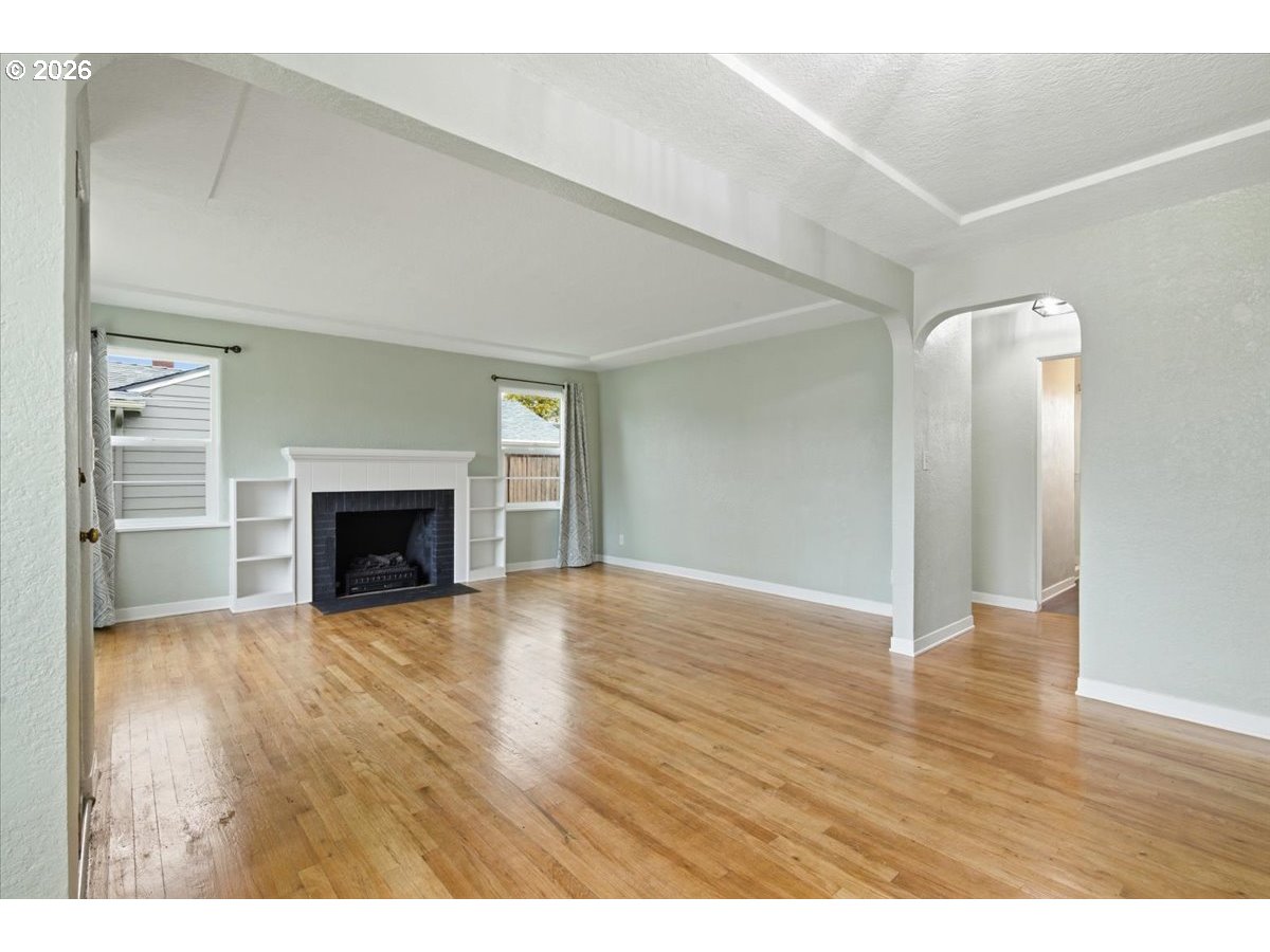 1084 24th Street Northeast Salem, OR 97301 - Photo 7 of 30 a view of empty room with wooden floor and fireplace