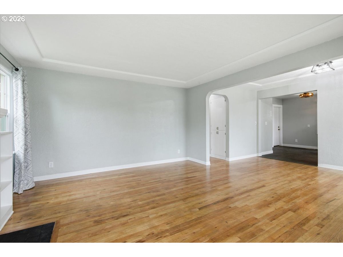1084 24th Street Northeast Salem, OR 97301 - Photo 8 of 30 a view of an empty room with wooden floor and a window