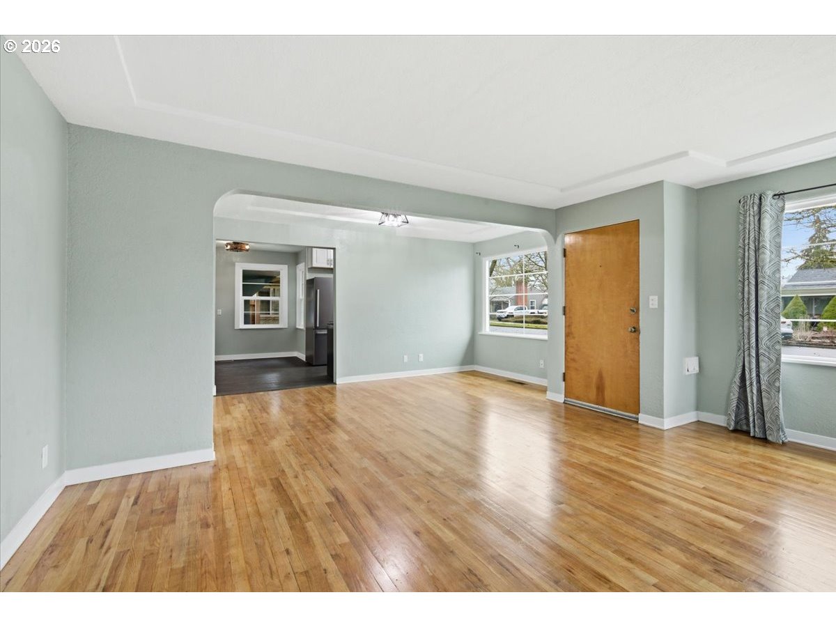 1084 24th Street Northeast Salem, OR 97301 - Photo 9 of 30 a view of an empty room with window and wooden floor
