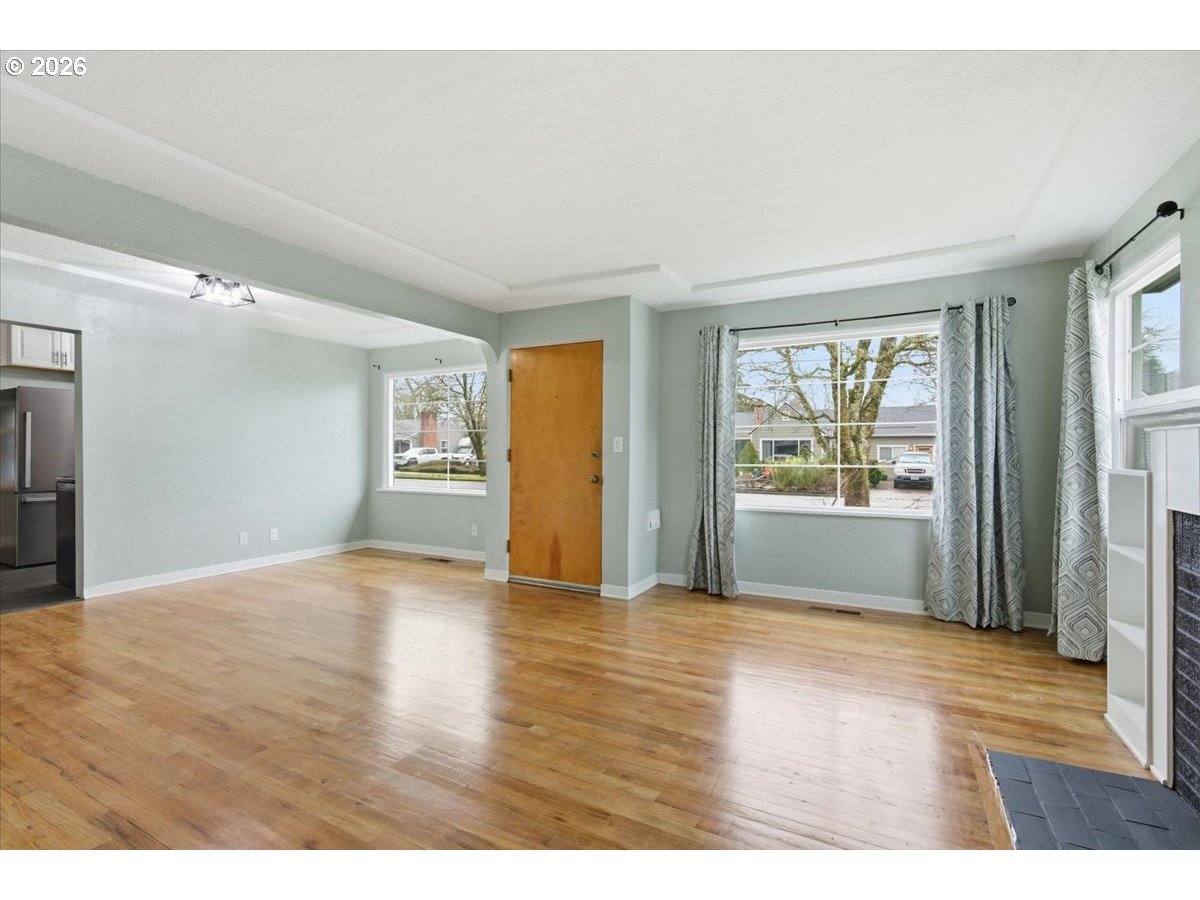 1084 24th Street Northeast Salem, OR 97301 - Photo 10 of 30 a view of an empty room with a window and wooden floor