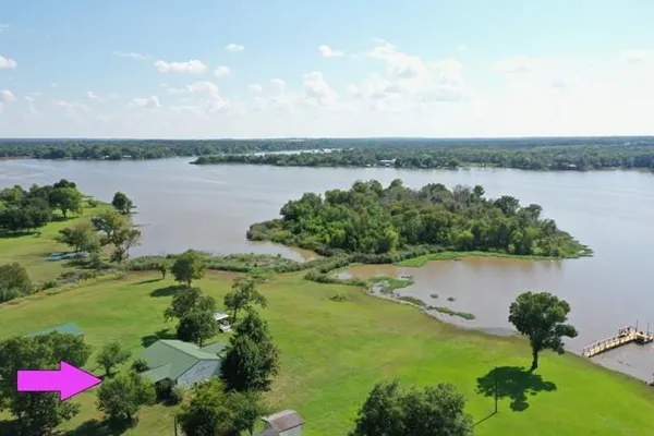 a view of a lake with houses in the back