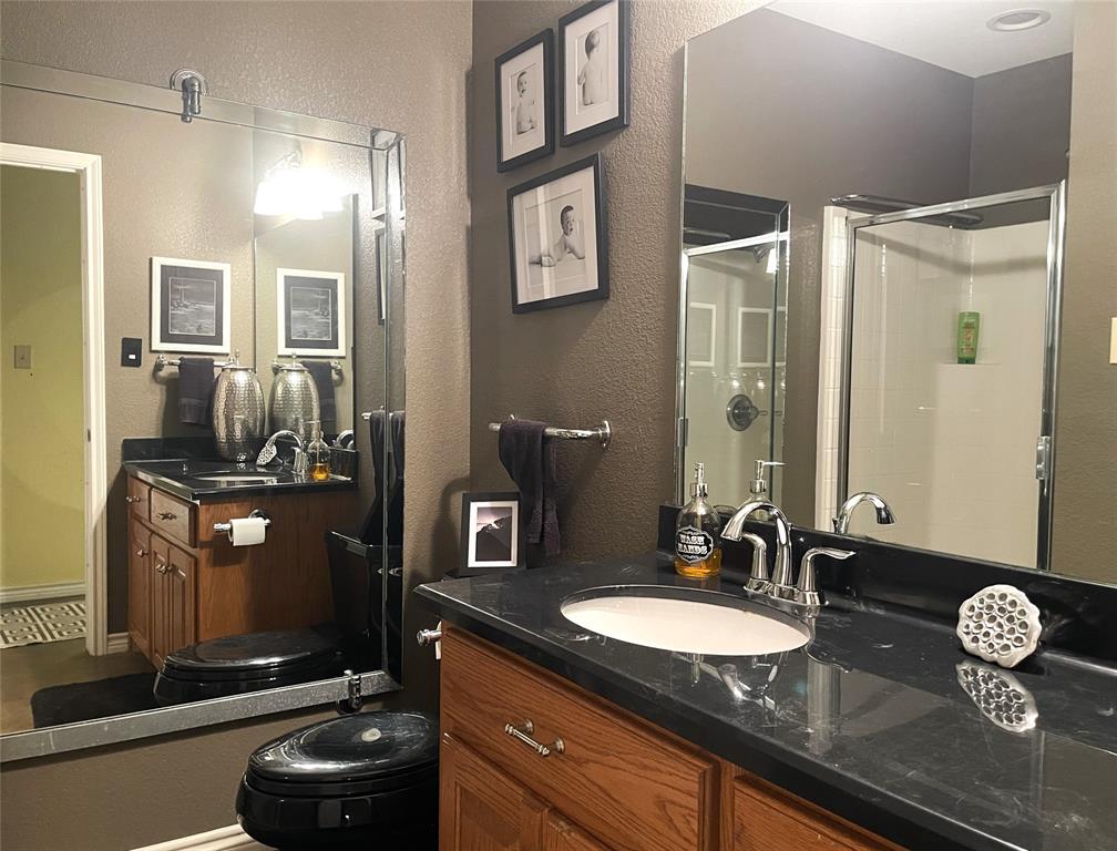 151 Lcr Cedar C3 Mexia, TX 76667 - Photo 18 of 28 a bathroom with a granite countertop sink a mirror and shower