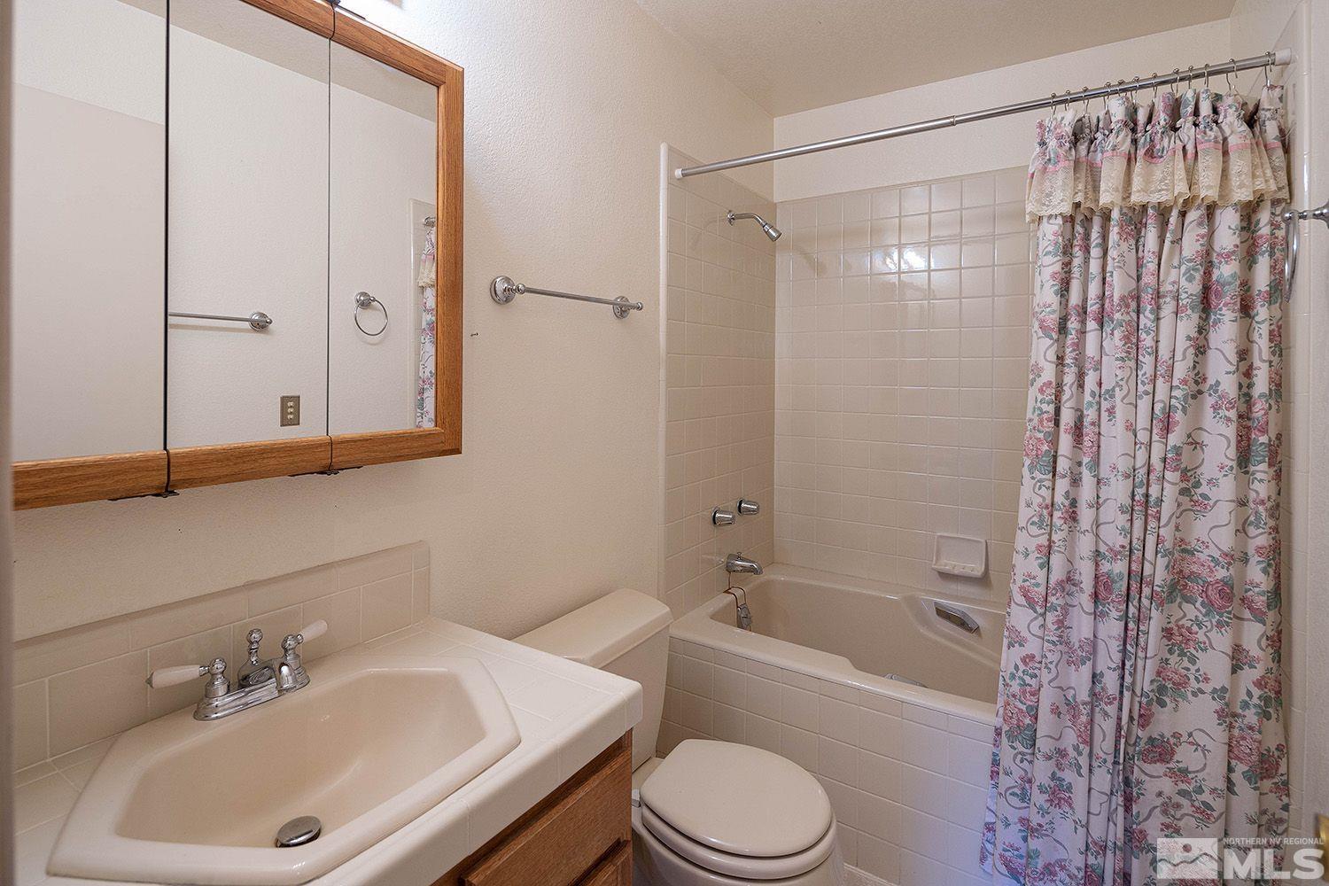 21400 Graves Road Reno, NV 89521 - Photo 13 of 21 a bathroom with a sink a toilet and shower