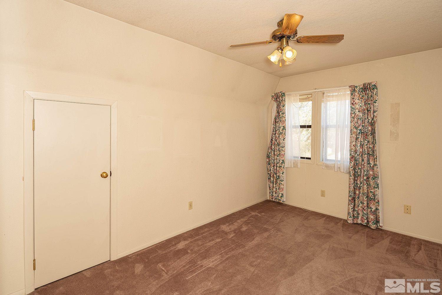 21400 Graves Road Reno, NV 89521 - Photo 14 of 21 a view of a livingroom with a ceiling fan and window