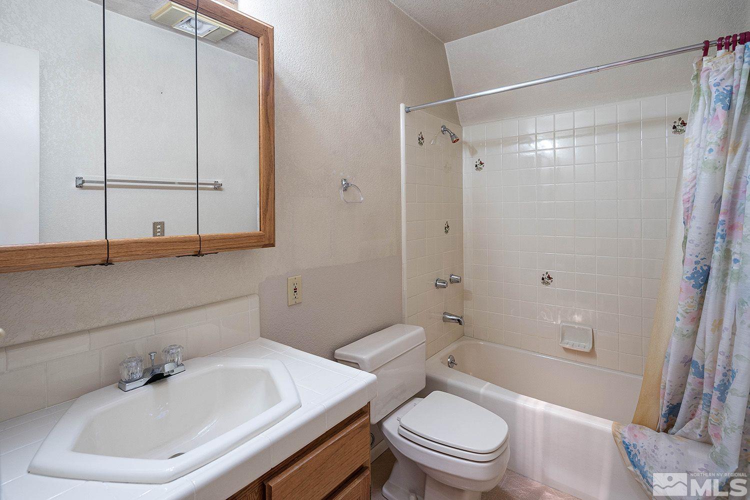 21400 Graves Road Reno, NV 89521 - Photo 15 of 21 a bathroom with a sink toilet and shower