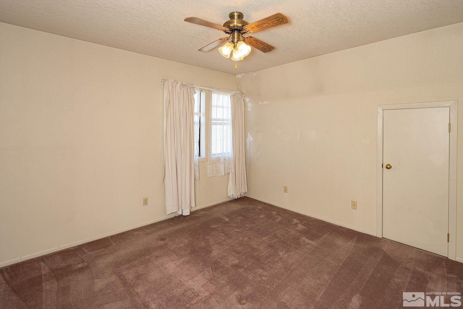 21400 Graves Road Reno, NV 89521 - Photo 16 of 21 an empty room with windows and fan