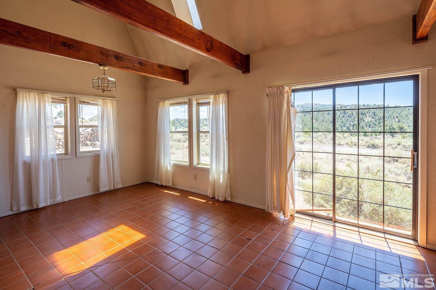 21400 Graves Road Reno, NV 89521 - Photo 5 of 21 a view of an empty room with glass door and balcony