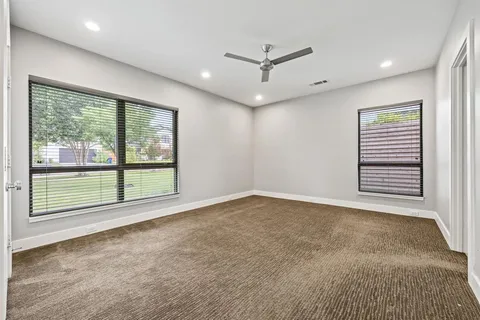 a bathroom with a sink a toilet a mirror a vanity a bathtub and shower