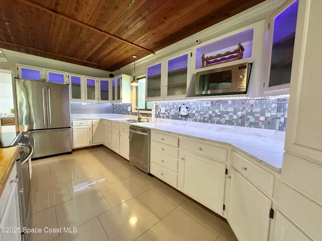 a kitchen with stainless steel appliances granite countertop a sink and a microwave