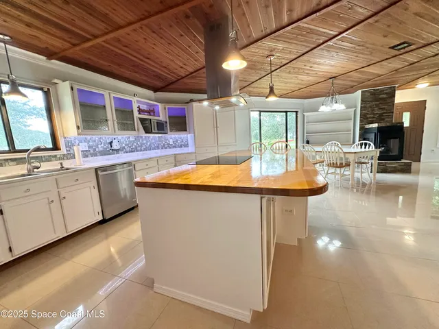 a kitchen with stainless steel appliances granite countertop a sink and cabinets