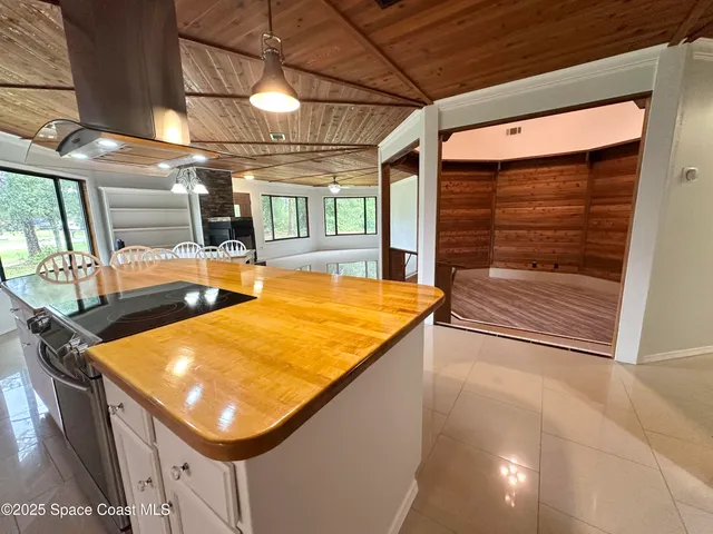 a room with pool table and windows