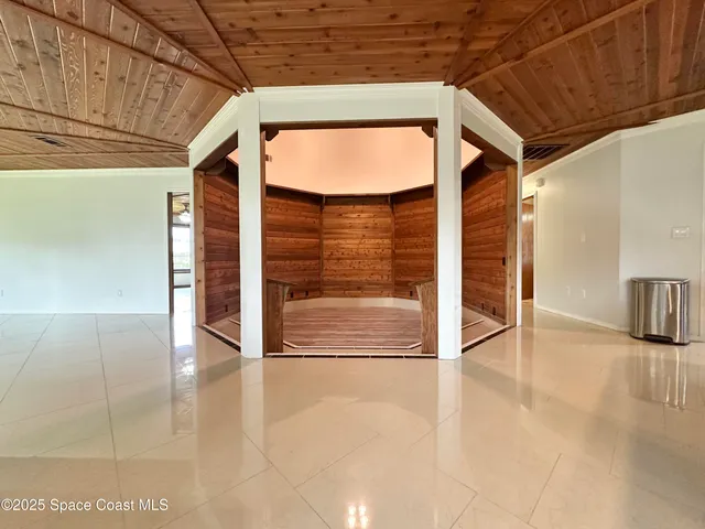 a view of a porch with wooden floor and fence