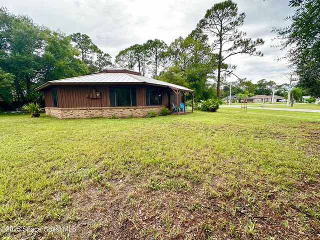 a view of a backyard with large trees