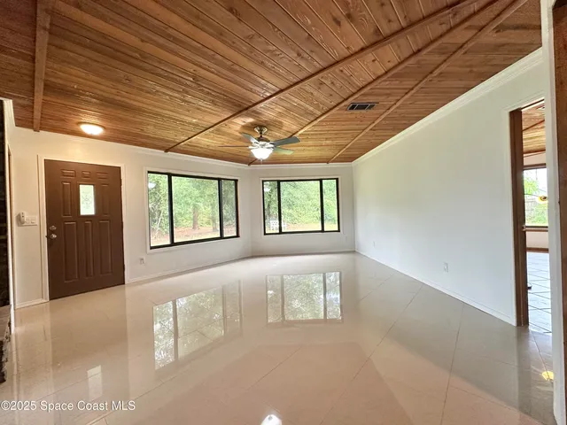 a view of an empty room with windows