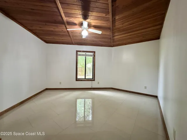 a en suite bathroom with a granite countertop sink and a mirror
