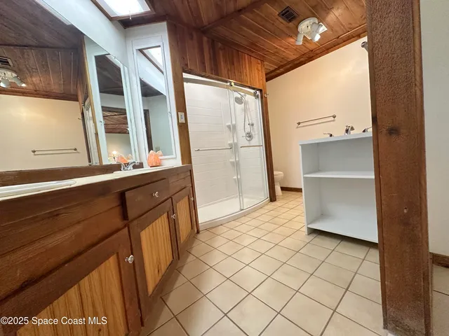 a bathroom with a sink a mirror and a shower