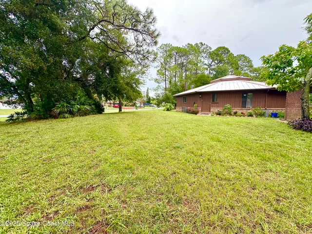 a yellow house with a yard