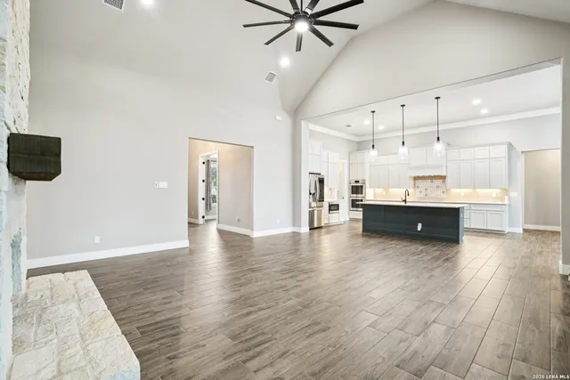 a view of a kitchen with wooden floor and a sink