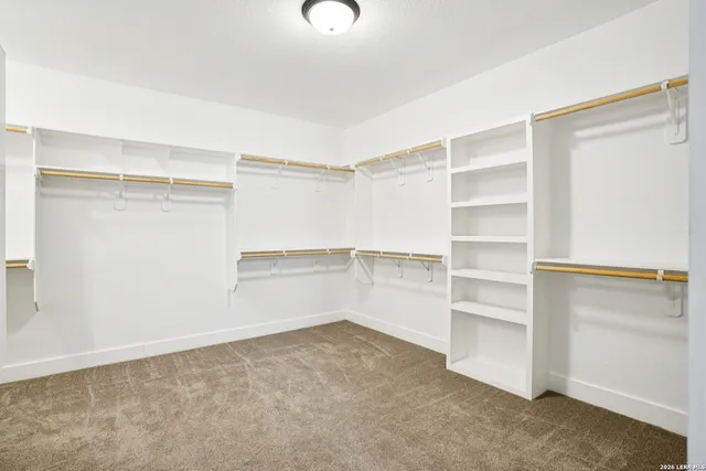 a view of walk in closet with empty racks