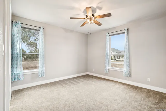 a view of a livingroom with a chandelier fan and closet area