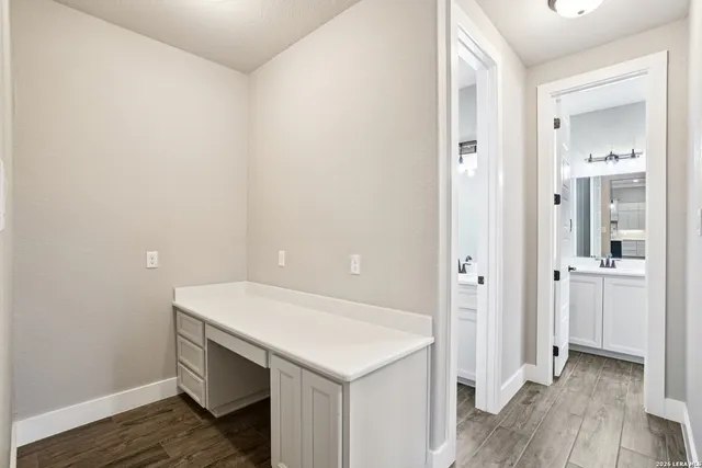 a view of walk in closet with wooden floor