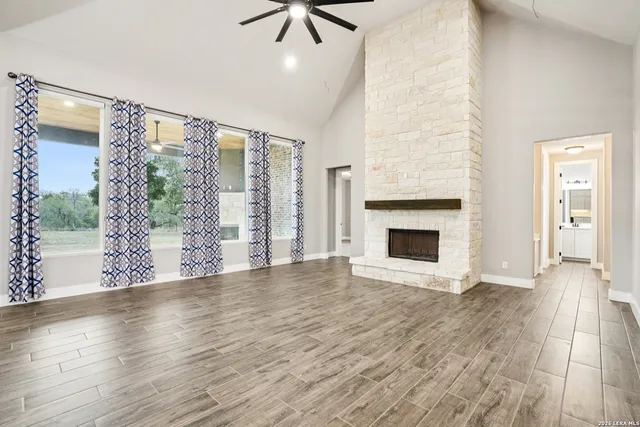 wooden floor fireplace and windows in an empty room