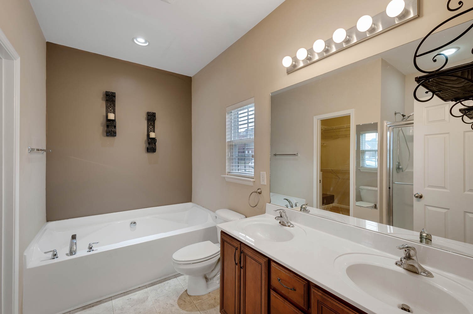 4074 Locerbie Circle Spring Hill, TN 37174 - Photo 11 of 23 a bathroom with a tub a sink and mirror