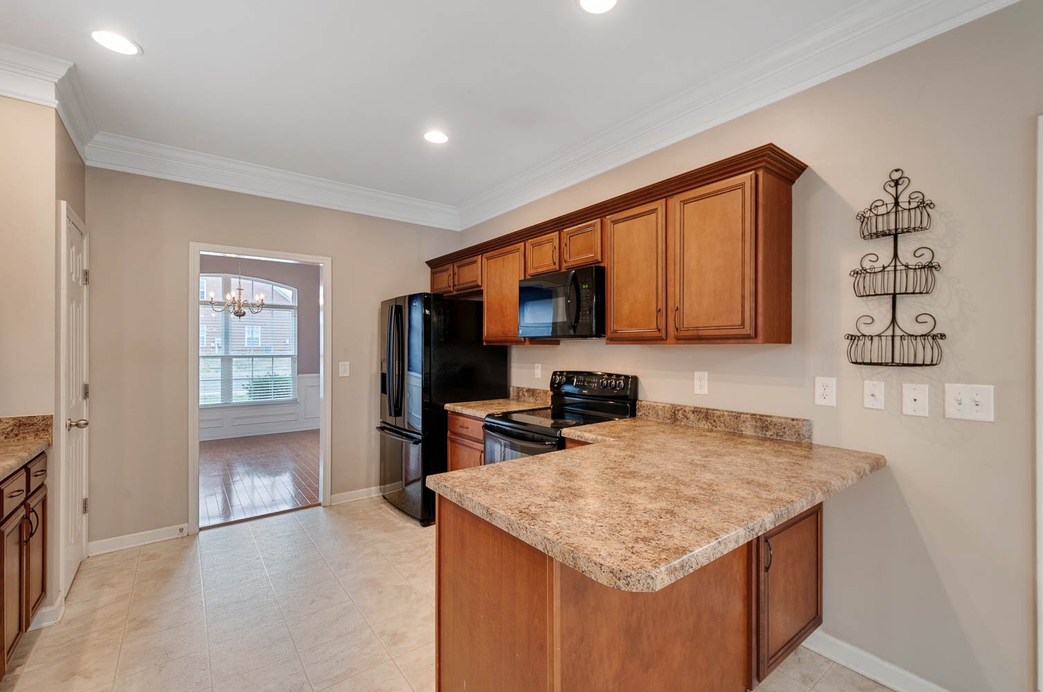 4074 Locerbie Circle Spring Hill, TN 37174 - Photo 5 of 23 a kitchen with stainless steel appliances granite countertop a sink stove microwave and refrigerator