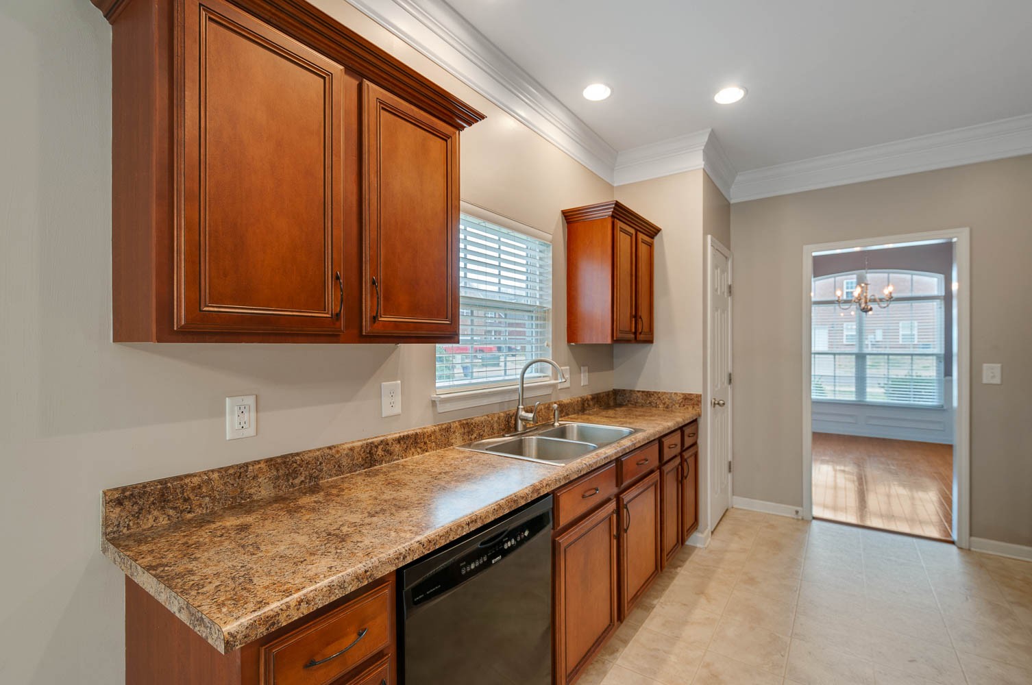 4074 Locerbie Circle Spring Hill, TN 37174 - Photo 6 of 23 a kitchen with a sink and a wooden cabinets