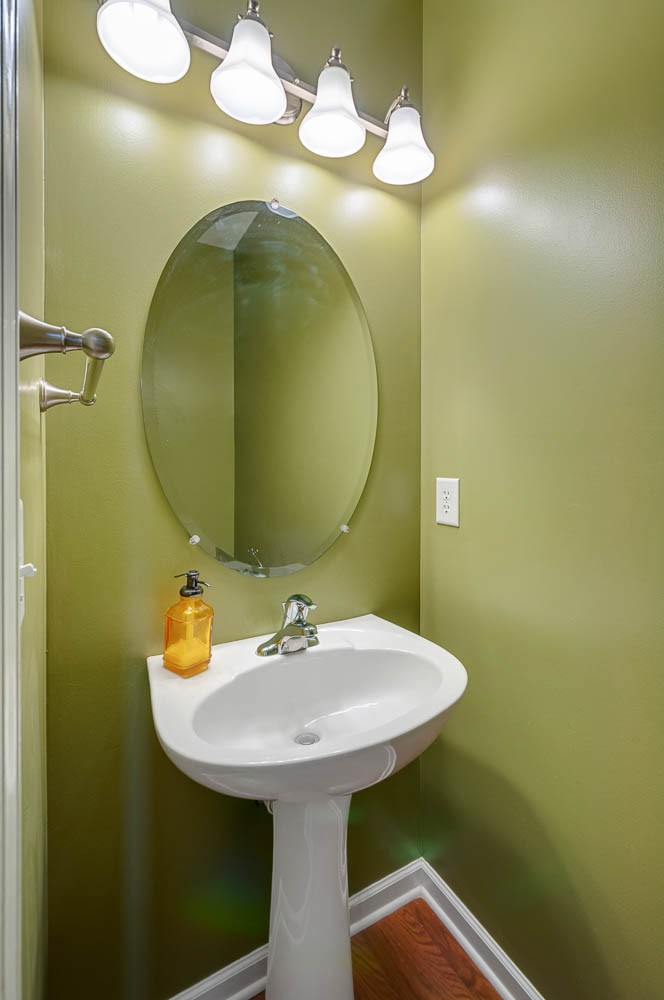 4074 Locerbie Circle Spring Hill, TN 37174 - Photo 8 of 23 a bathroom with a sink and mirror