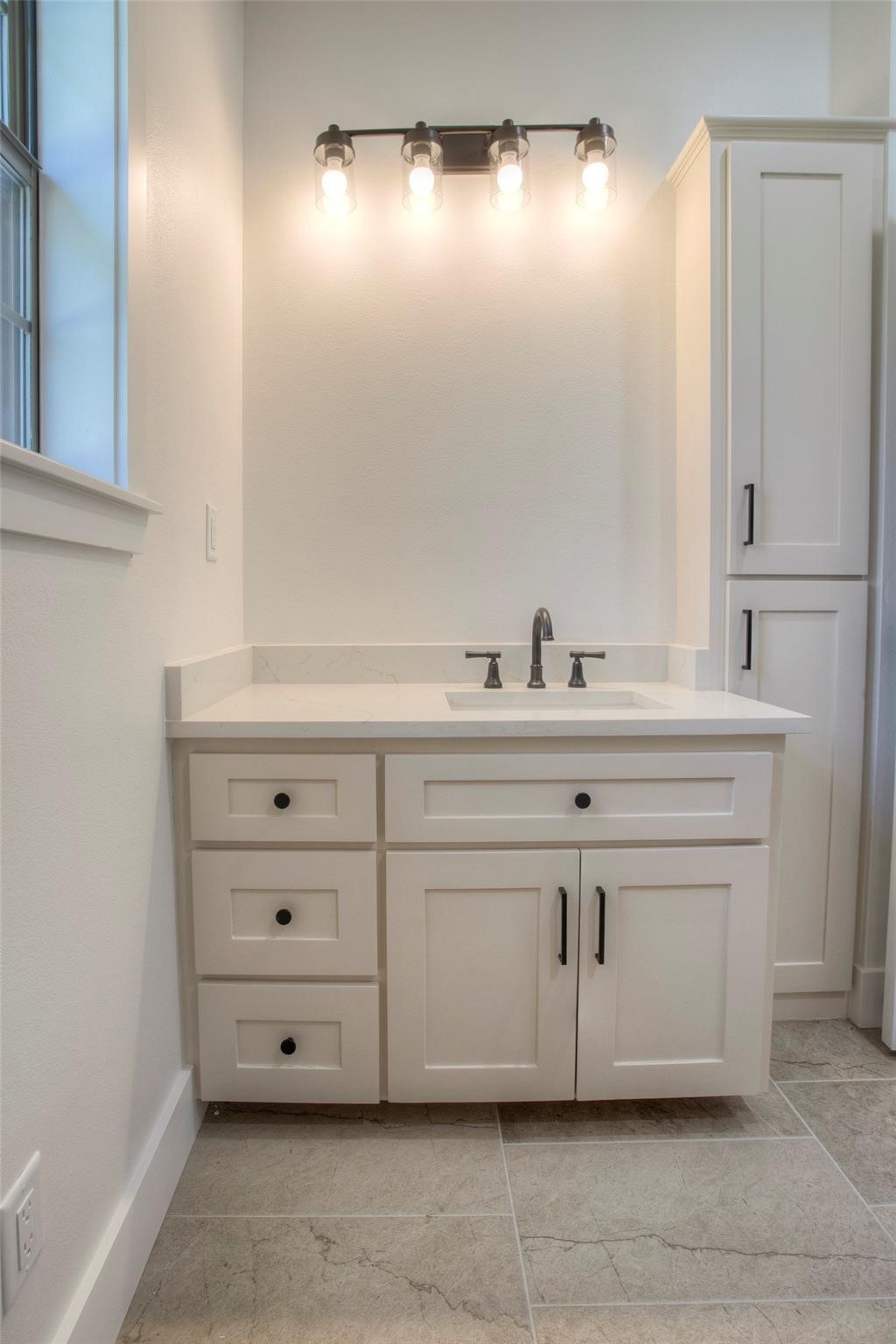 83 Dahlia Road Huntsville, TX 77320 - Photo 34 of 49 a bathroom with a sink and a mirror