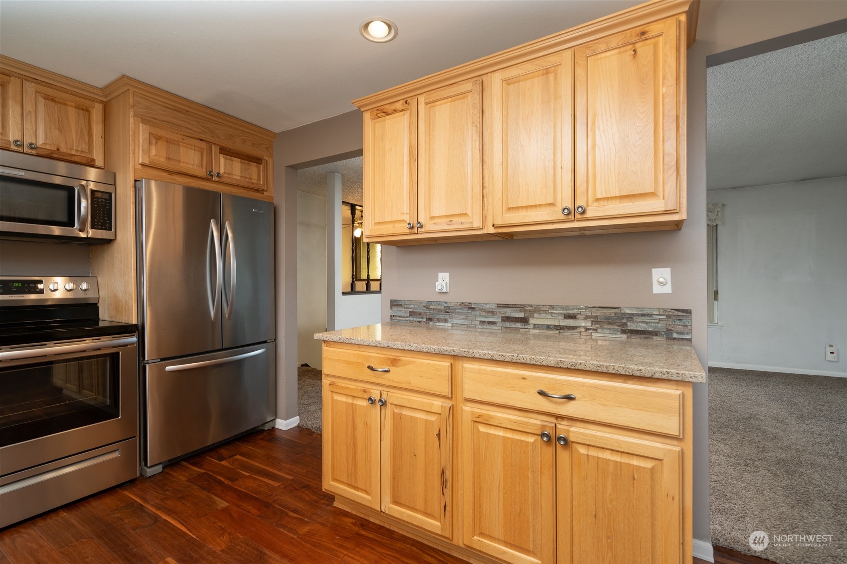 16678 Dike Road Mount Vernon, WA 98273 - Photo 13 of 37 a kitchen with granite countertop wooden cabinets and stainless steel appliances
