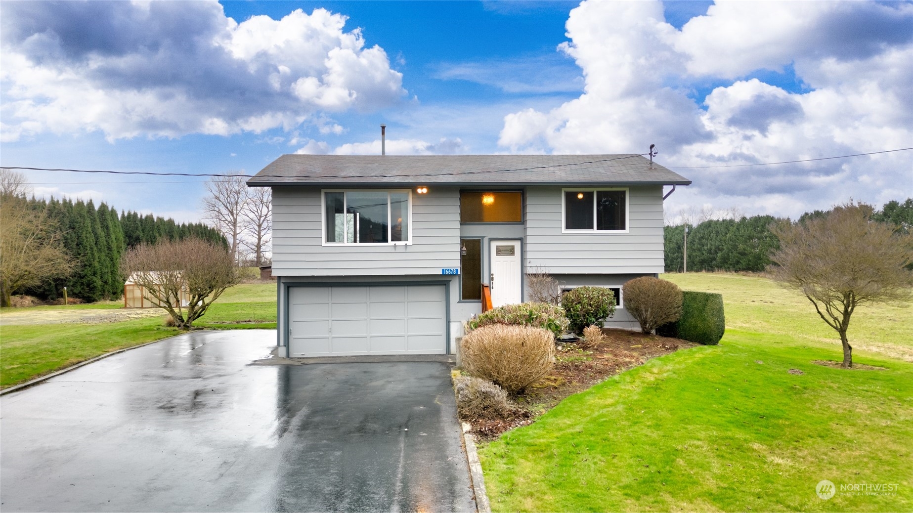 16678 Dike Road Mount Vernon, WA 98273 - Photo 2 of 37 a front view of a house with garden and patio