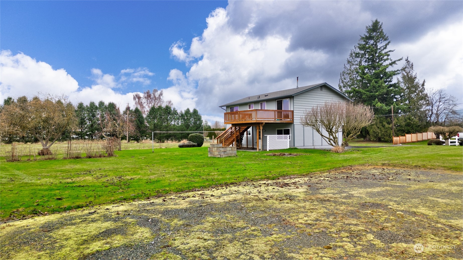 16678 Dike Road Mount Vernon, WA 98273 - Photo 31 of 37 a view of a house with a big yard and large trees