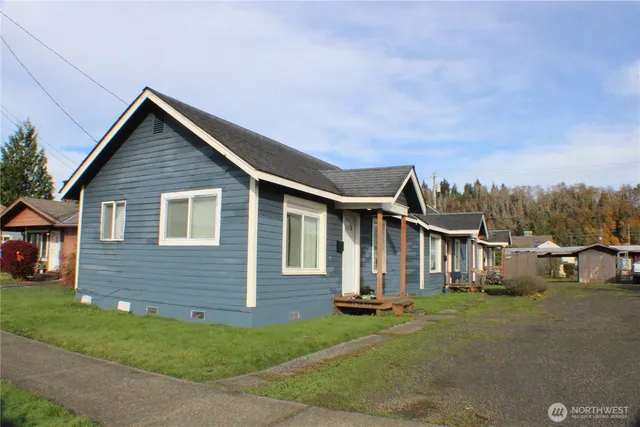 a front view of house with yard and green space